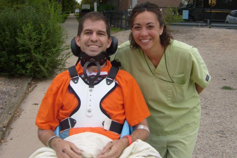 Chris in a wheelchair just outside Kindred Hospital in Denver