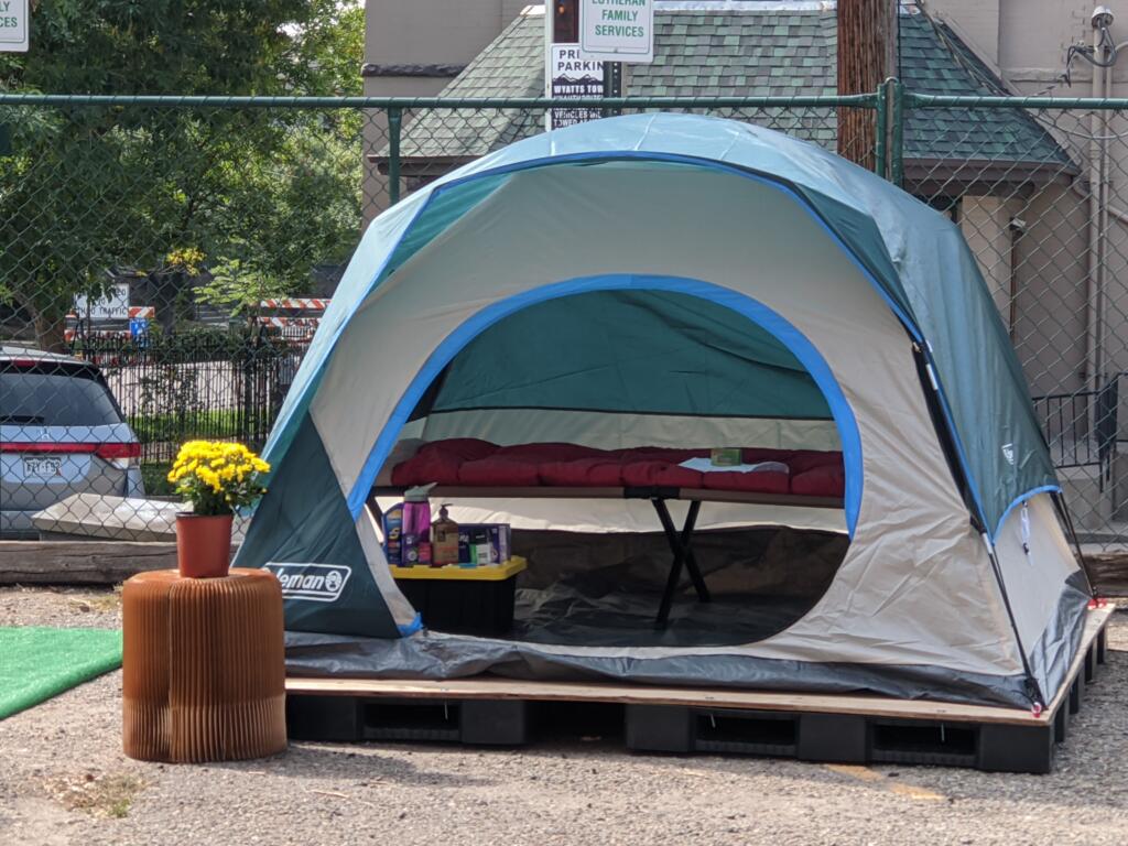 Tent with blue color tones on a palette to keep the tent from directly touching the ground